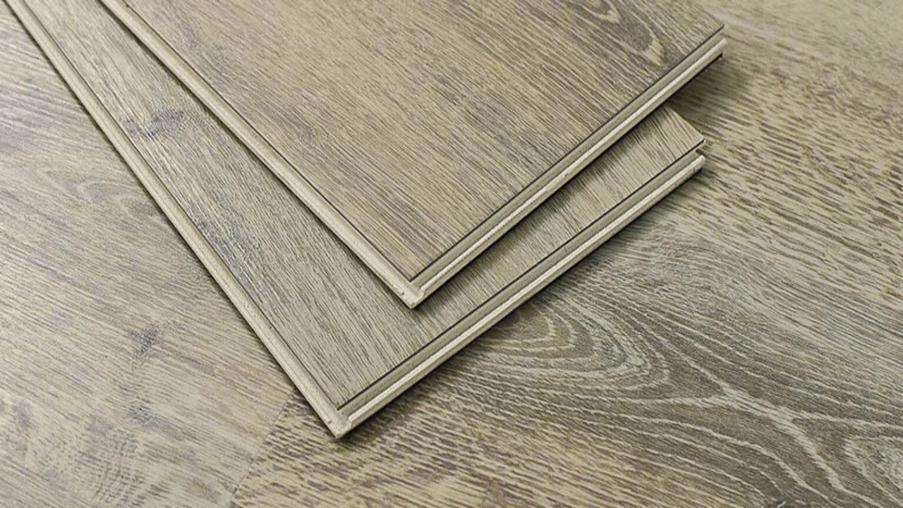 Two click-lock vinyl planks showing tongue-and-groove click edges