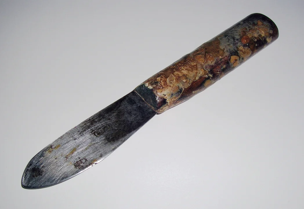 Worn putty knife with a wooden handle
