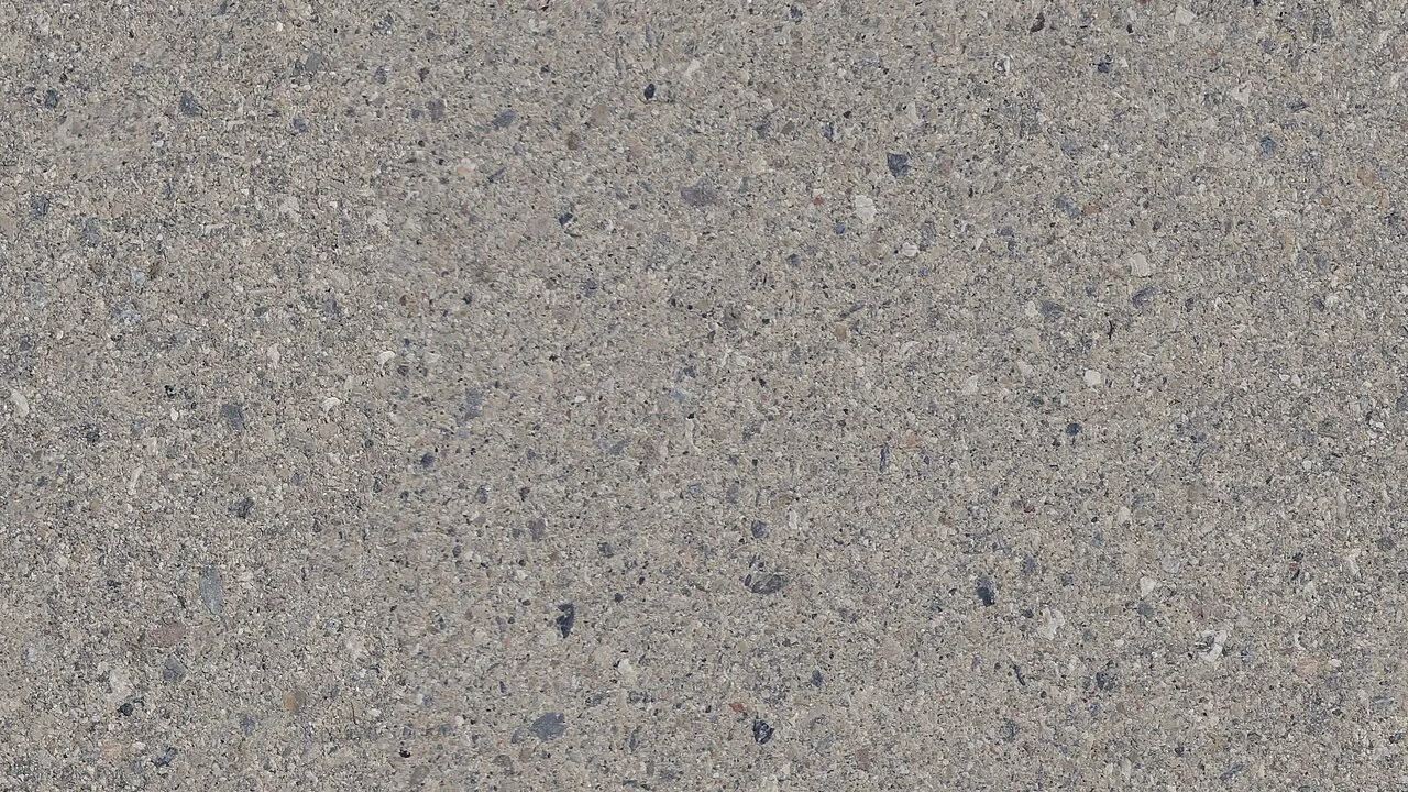 Stone Vinyl Flooring (2026): Which Stone Look Fits Your Room Grey flecked stone-look tiled floor surface